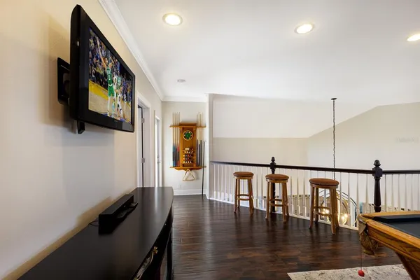 a hallway with wooden floor dining table and chairs
