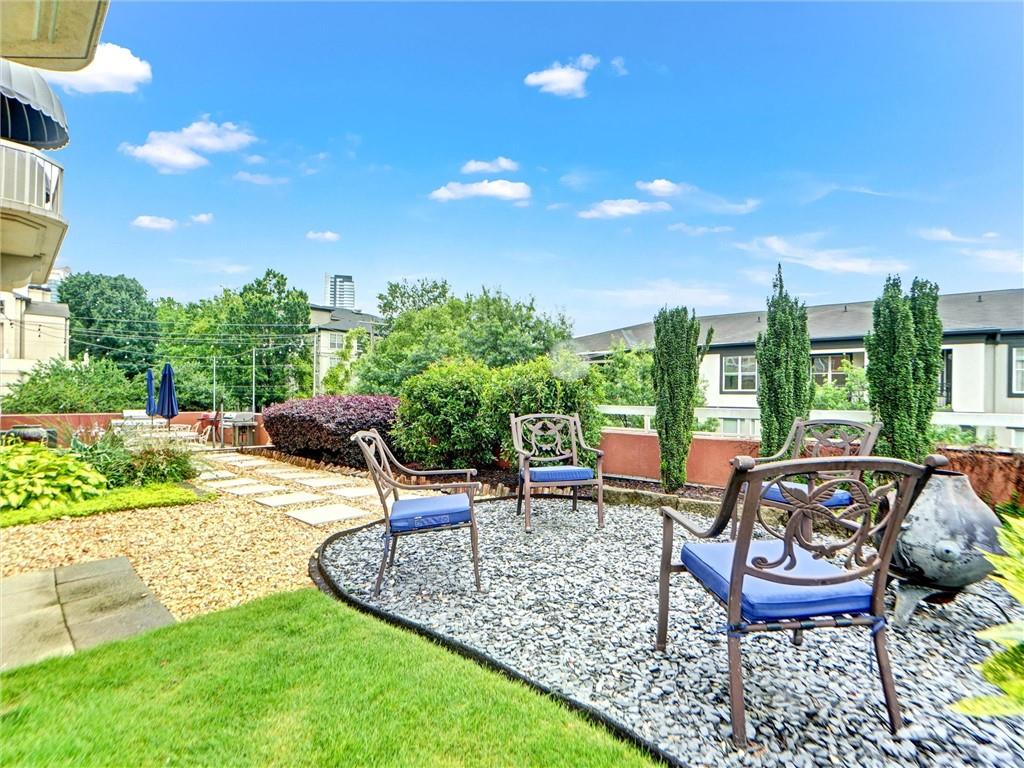 3435 Kingsboro Road Northeast, Unit 1601 Atlanta, GA 30326 - Photo 44 of 54 a view of a patio with table and chairs and potted plants