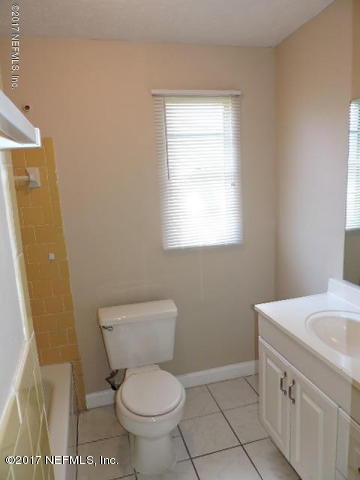 410 Skate Road Atlantic Beach, FL 32233 - Photo 14 of 31 a bathroom with a sink a toilet and a window