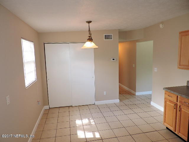 410 Skate Road Atlantic Beach, FL 32233 - Photo 4 of 31 a view of an empty room with window and chandelier fan