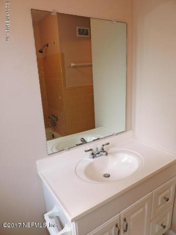 410 Skate Road Atlantic Beach, FL 32233 - Photo 9 of 31 a bathroom with a sink and a mirror