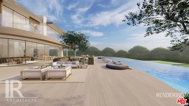 a view of a patio with couches and chairs under an umbrella with a fire pit