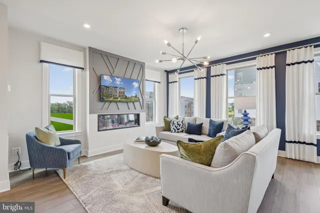 a living room with furniture a flat screen tv and a large window