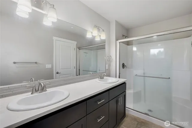 a bathroom with a double vanity sink mirror and double