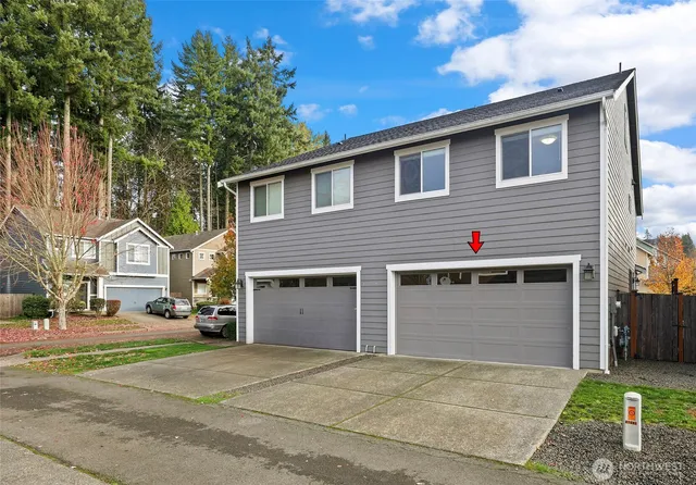 a front view of a house with a yard and garage