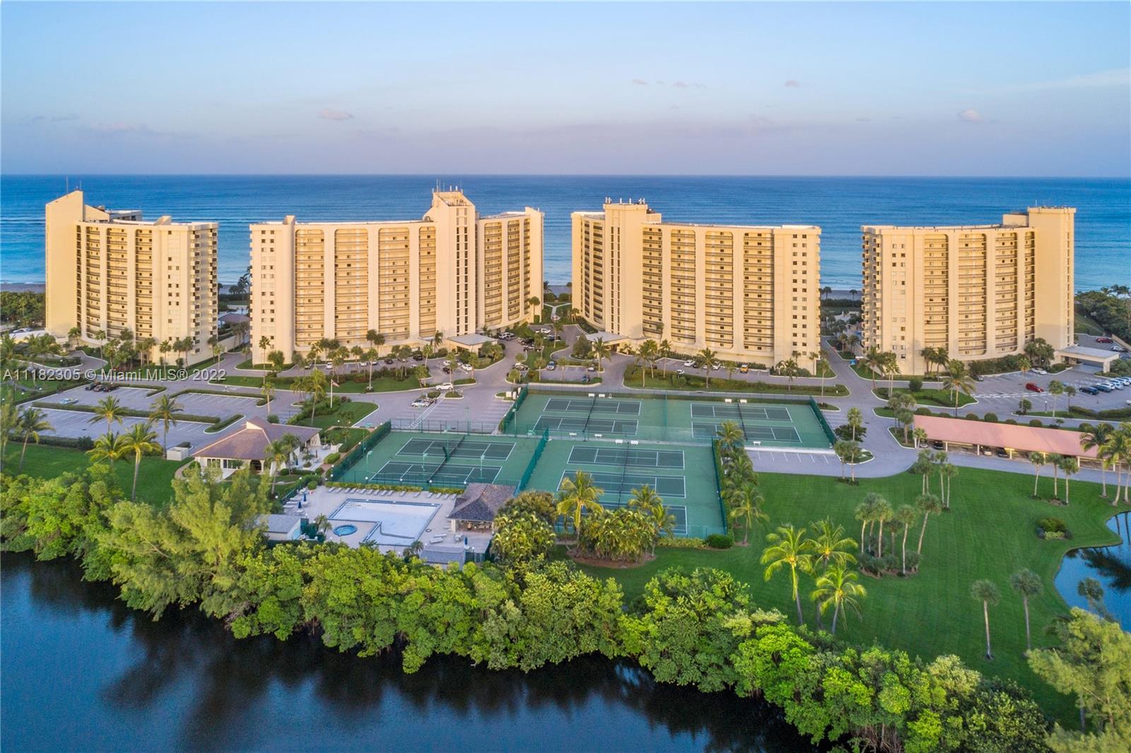 300 Ocean Trail Way, Unit 104 Jupiter, FL 33477 - Photo 18 of 26 a swimming pool with outdoor seating and plants