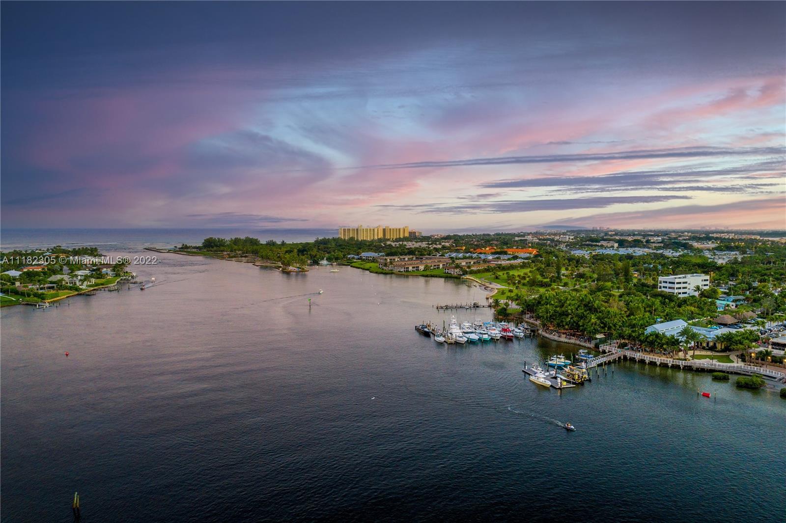 300 Ocean Trail Way, Unit 104 Jupiter, FL 33477 - Photo 22 of 26 a view of a lake with a car parked