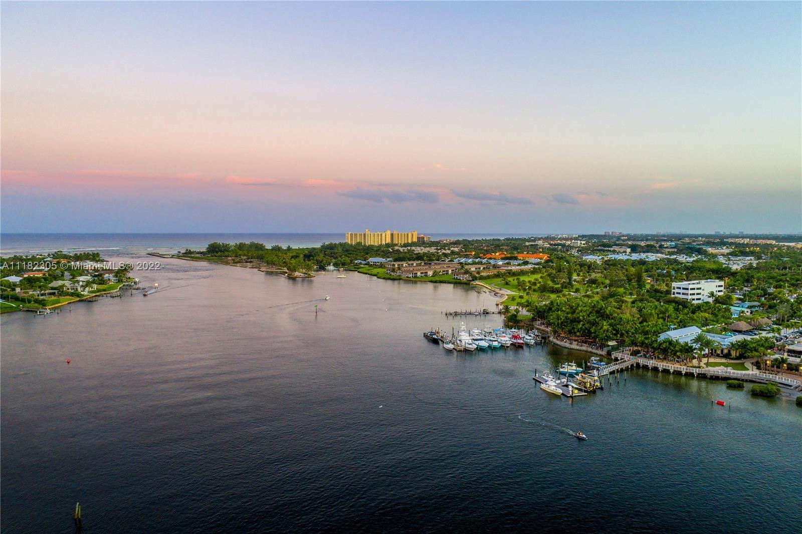 300 Ocean Trail Way, Unit 104 Jupiter, FL 33477 - Photo 23 of 26 a view of a lake with houses