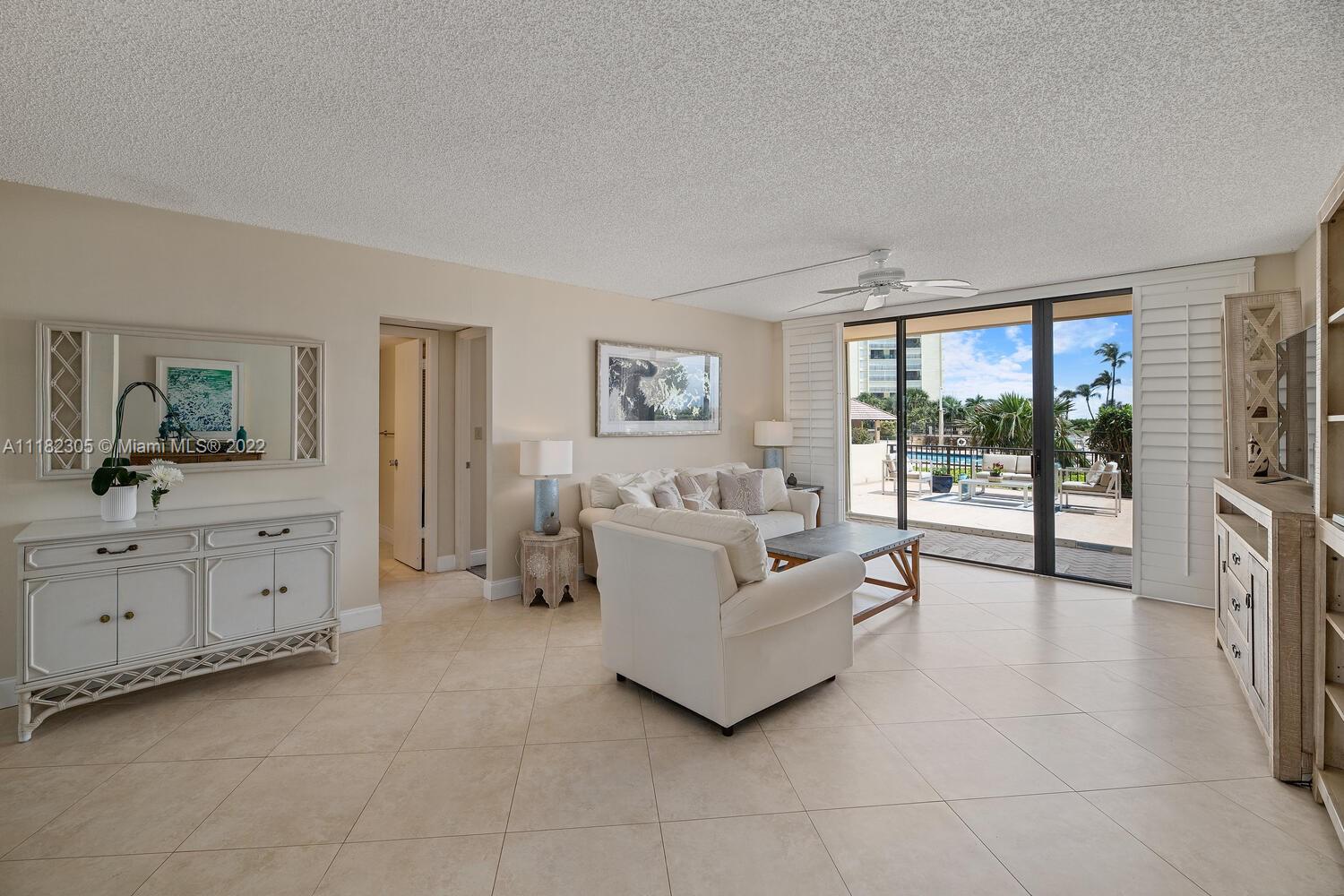 300 Ocean Trail Way, Unit 104 Jupiter, FL 33477 - Photo 8 of 26 a spacious bedroom with a balcony a bed and a large window