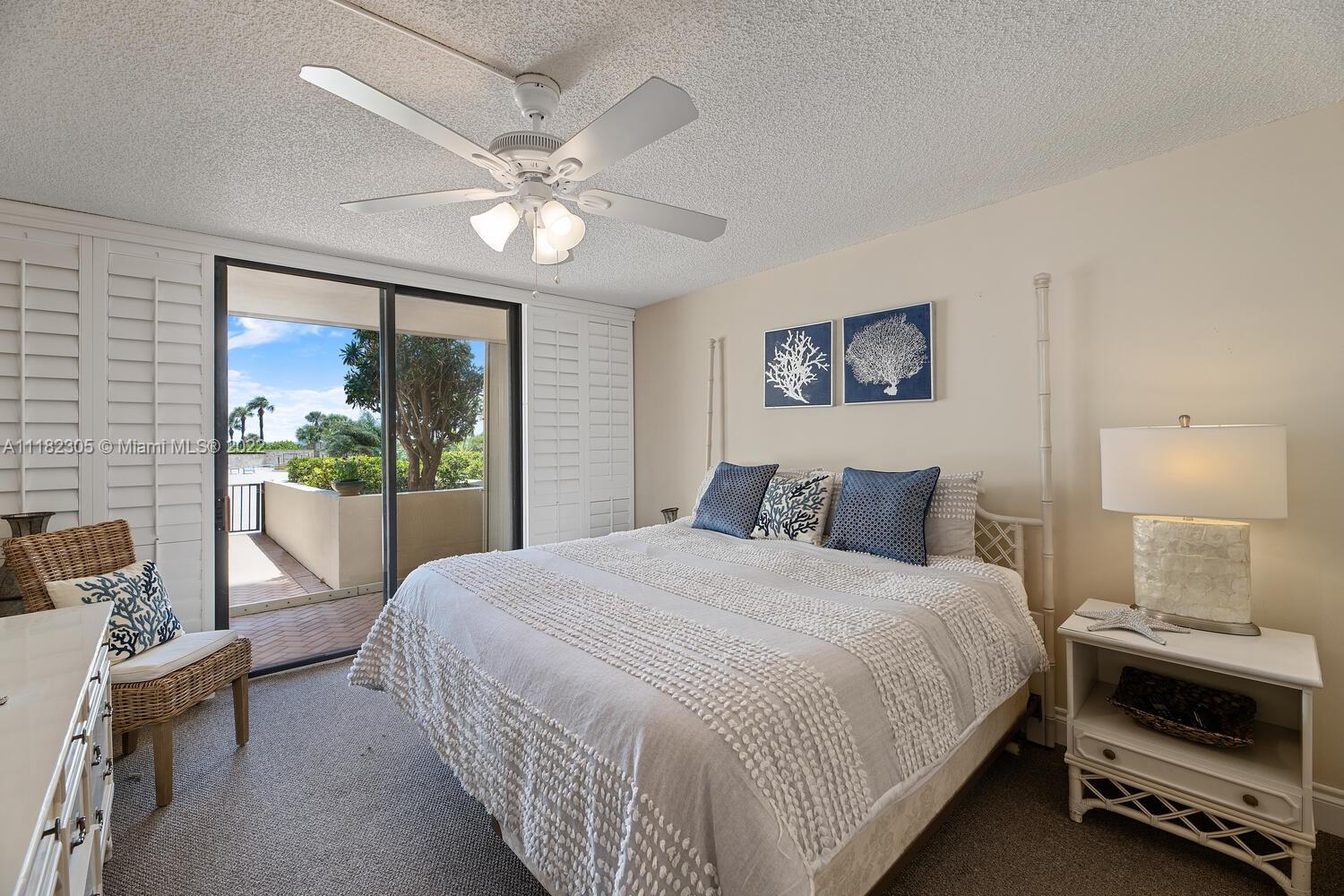 300 Ocean Trail Way, Unit 104 Jupiter, FL 33477 - Photo 9 of 26 a bedroom with a large bed and a window