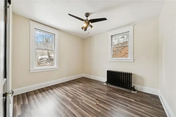 a view of workspace with wooden floor and ceiling fan