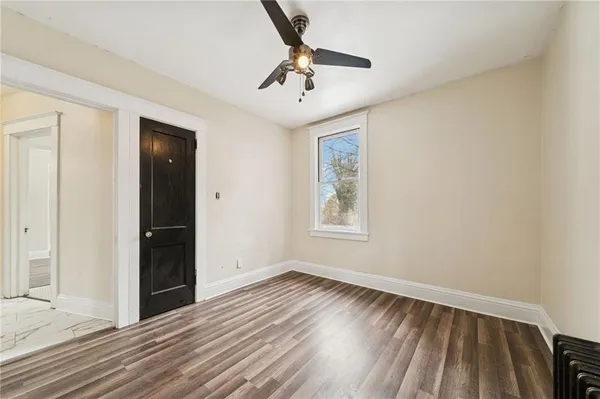 wooden floor in an empty room with a window