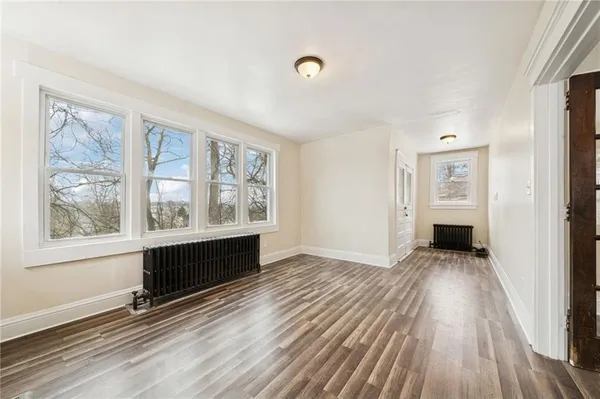 wooden floor in an empty room with a window