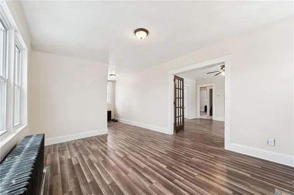 wooden floor in an empty room with a window