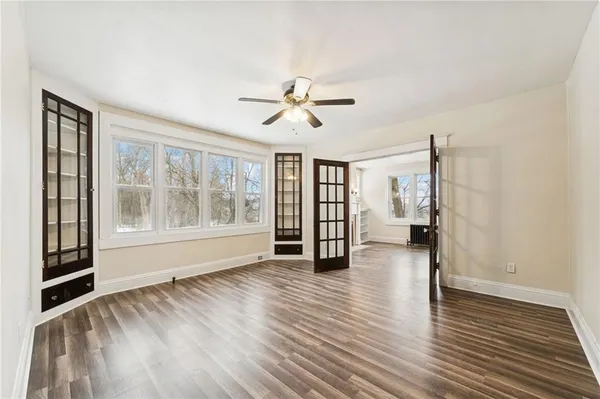 wooden floor in an empty room with a window