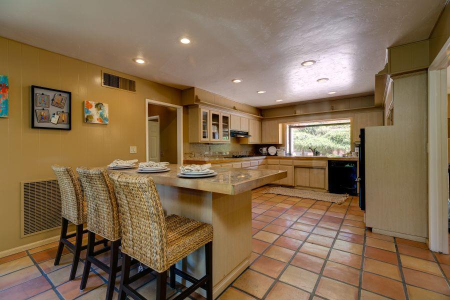 1195 Rancho Court Ojai, CA 93023 - Photo 13 of 49 a kitchen with granite countertop a sink cabinets and refrigerator