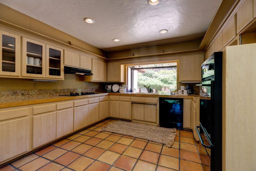 1195 Rancho Court Ojai, CA 93023 - Photo 14 of 49 a kitchen with a sink window and cabinets