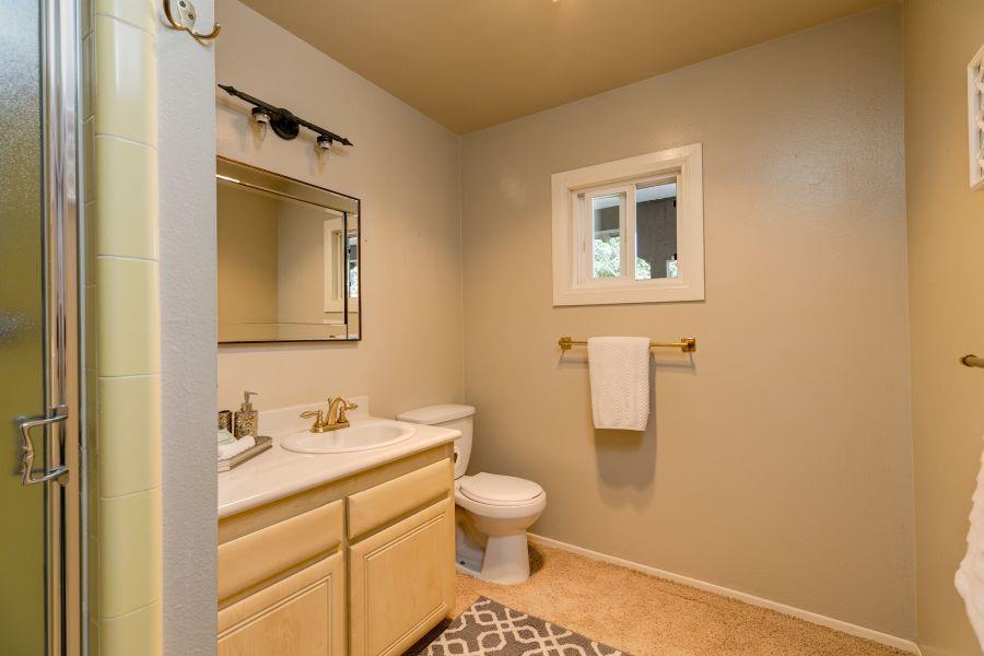 1195 Rancho Court Ojai, CA 93023 - Photo 27 of 49 a bathroom with a granite countertop toilet sink and mirror