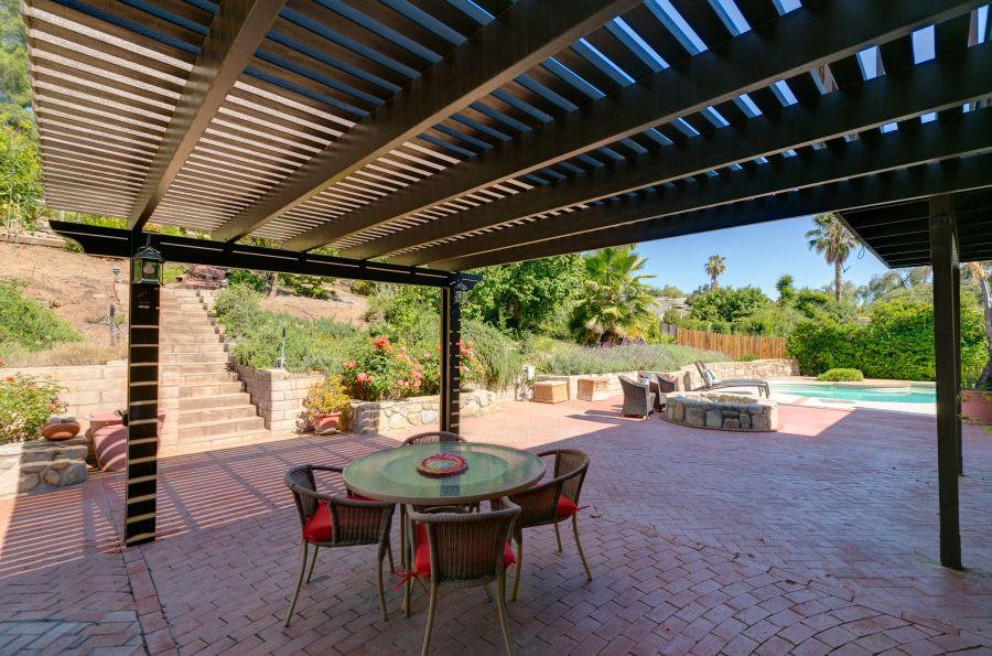1195 Rancho Court Ojai, CA 93023 - Photo 37 of 49 a view of a patio with a table and chairs and floor to ceiling window with wooden floor