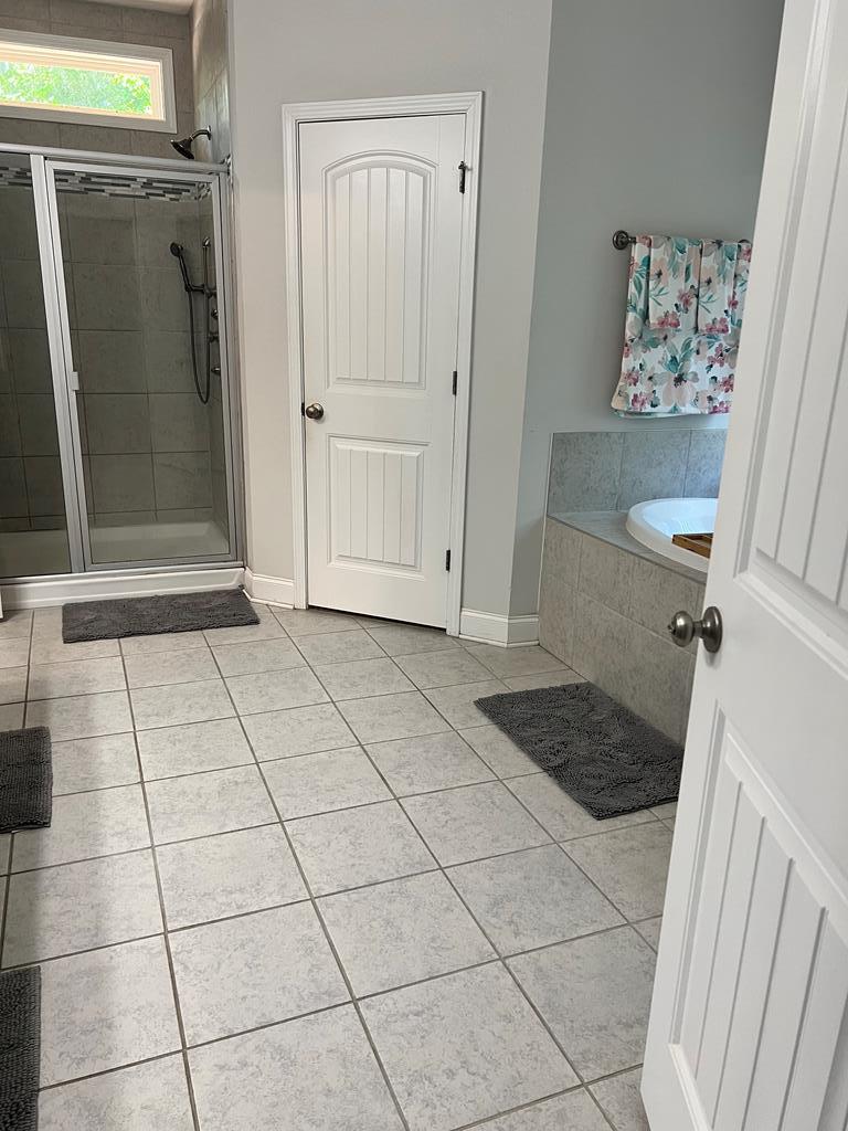 1048 Crosswinds Drive Midland, GA 31820 - Photo 11 of 25 a view of a refrigerator in kitchen and an empty room in wooden floor