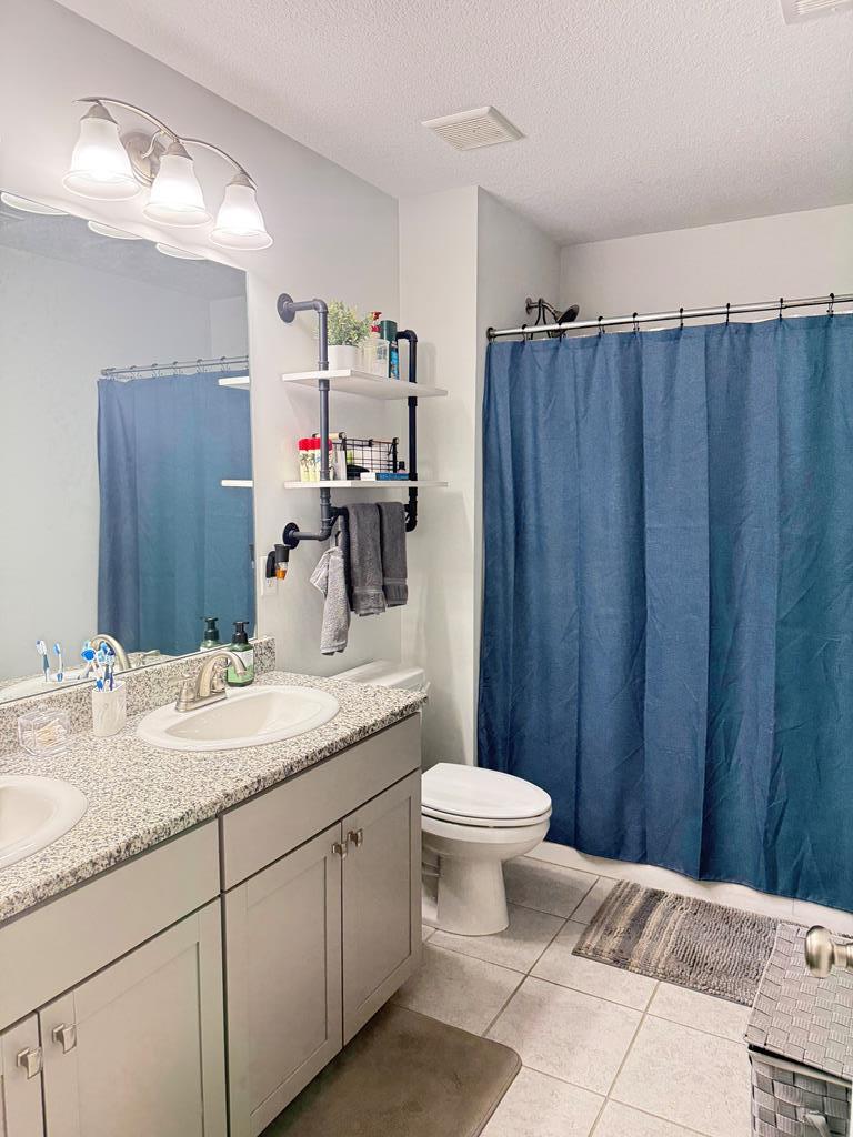 1048 Crosswinds Drive Midland, GA 31820 - Photo 17 of 25 a bathroom with a granite countertop sink toilet and mirror