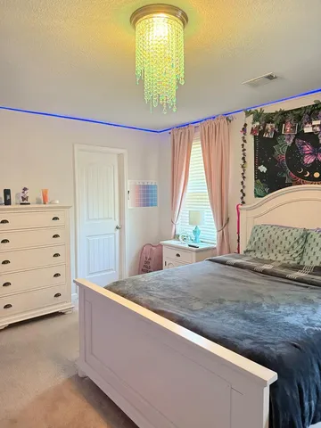 a living room with a bed furniture and a window