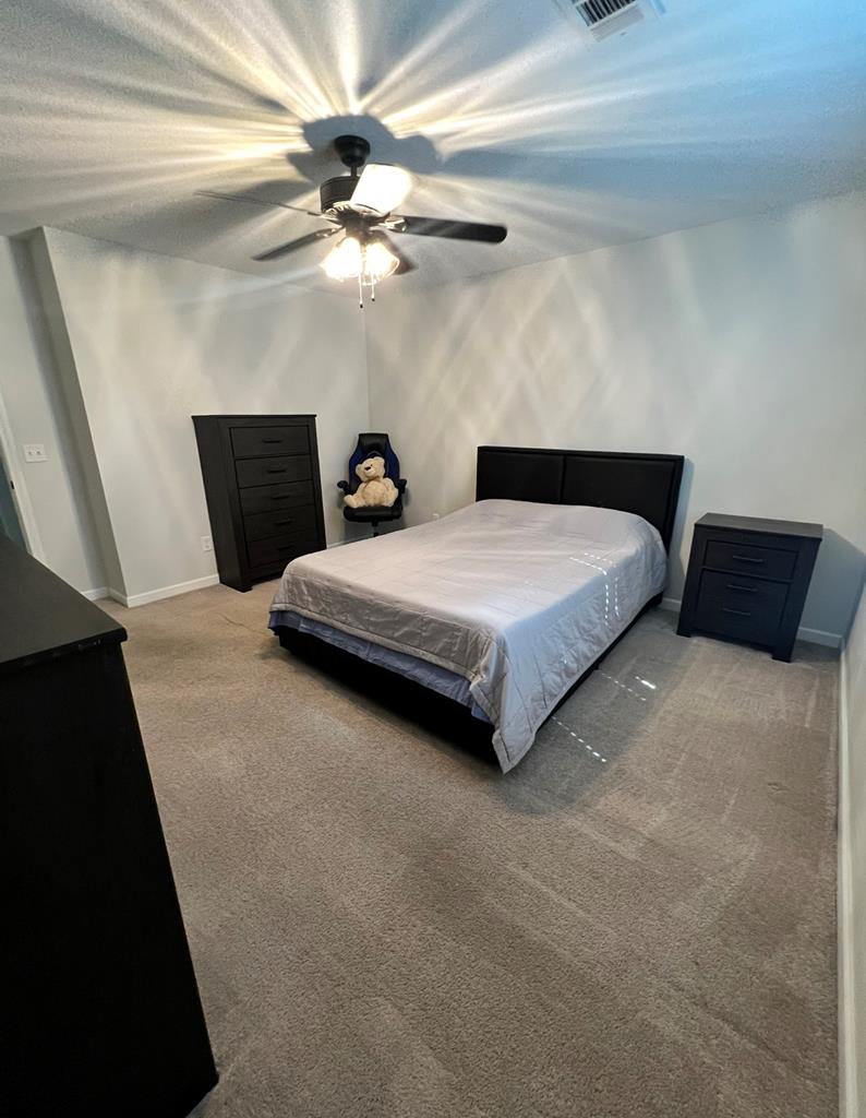 1048 Crosswinds Drive Midland, GA 31820 - Photo 22 of 25 a bedroom with bed and a chandelier