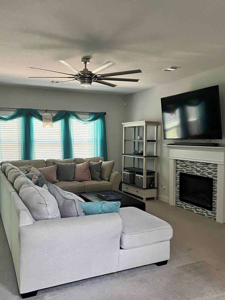 1048 Crosswinds Drive Midland, GA 31820 - Photo 4 of 25 a living room with furniture a fireplace and a flat screen tv