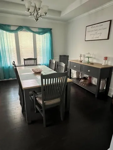 a dining room with furniture and window