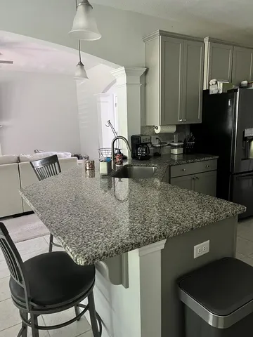 a kitchen with a table chairs and refrigerator