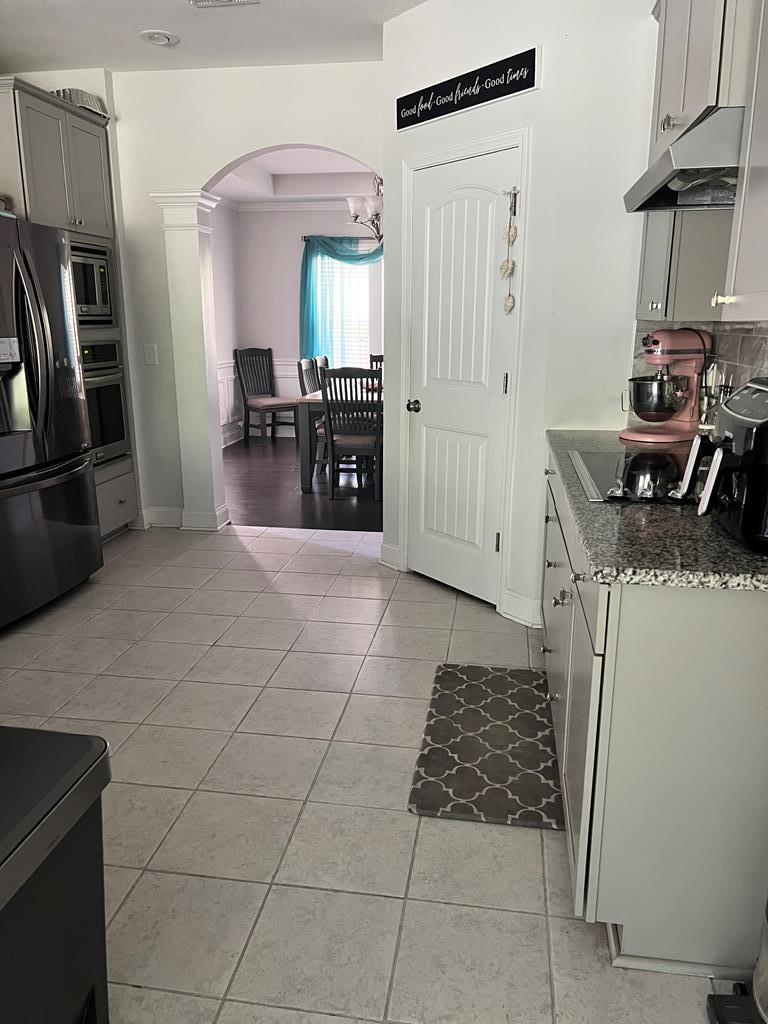 1048 Crosswinds Drive Midland, GA 31820 - Photo 7 of 25 a kitchen with granite countertop a stove a refrigerator and cabinets