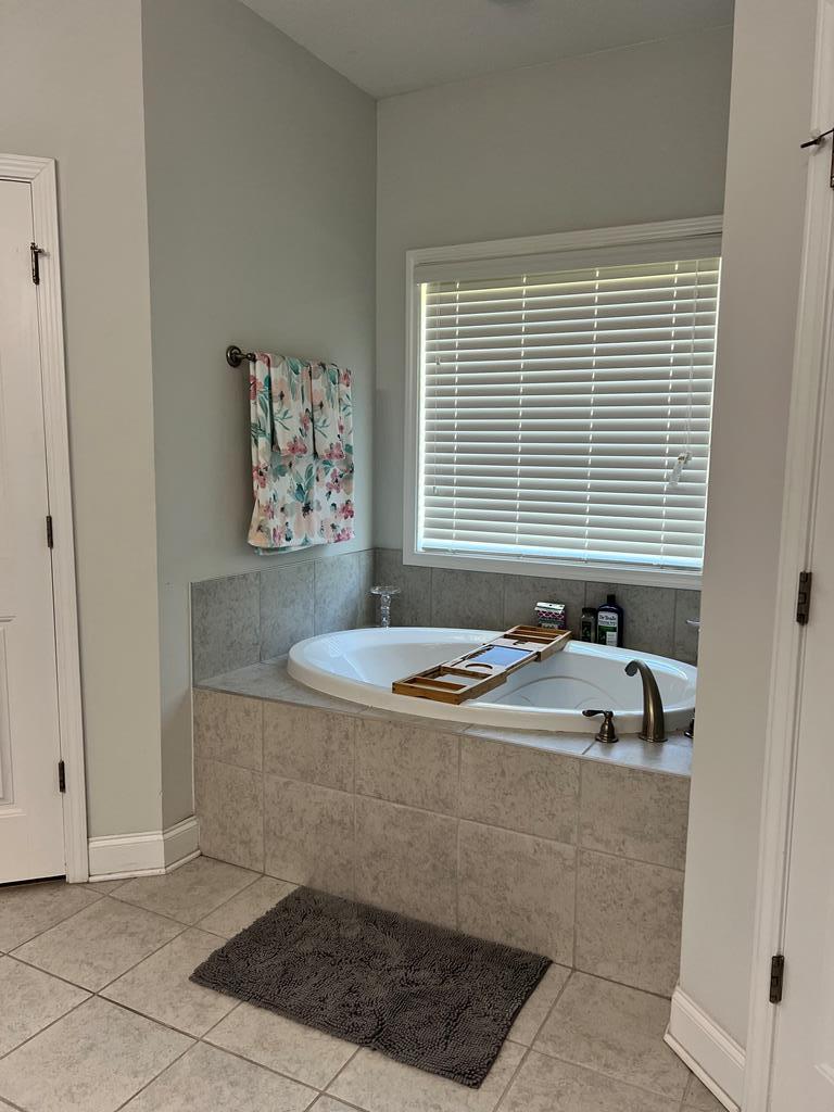 1048 Crosswinds Drive Midland, GA 31820 - Photo 10 of 25 a bath tub sitting in a bathroom next to a window