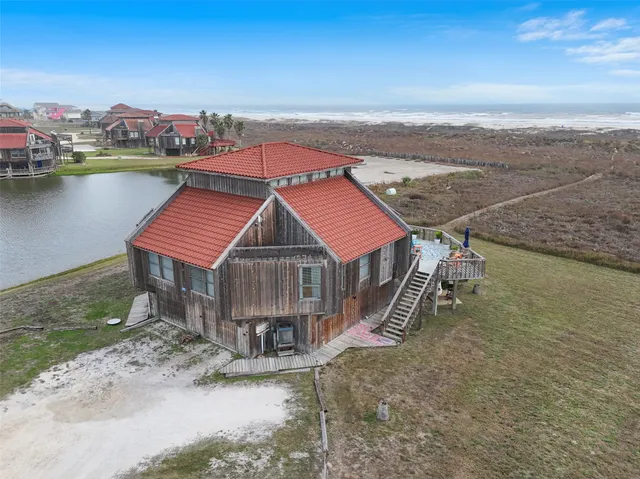 an aerial view of a house with a ocean view
