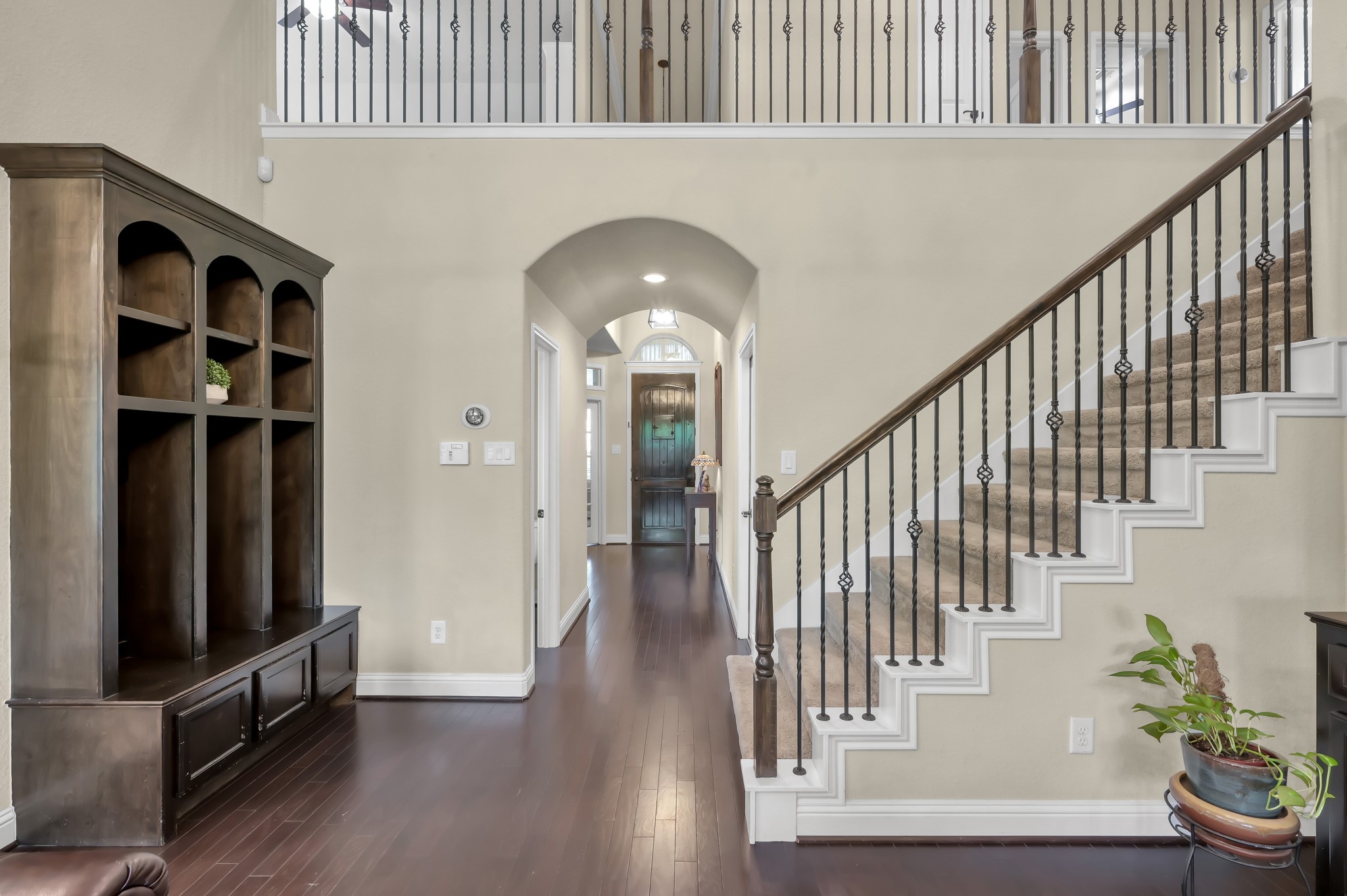 23 Rancher's Trail Tomball, TX 77375 - Photo 5 of 40 This inviting home greets you with a sophisticated touch, featuring elegant wrought iron railings that enhance its family room space.
