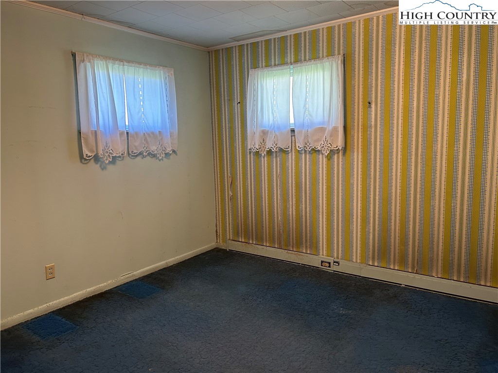 116 Cole Street Boone, NC 28607 - Photo 12 of 21 an empty room with wooden floor and windows