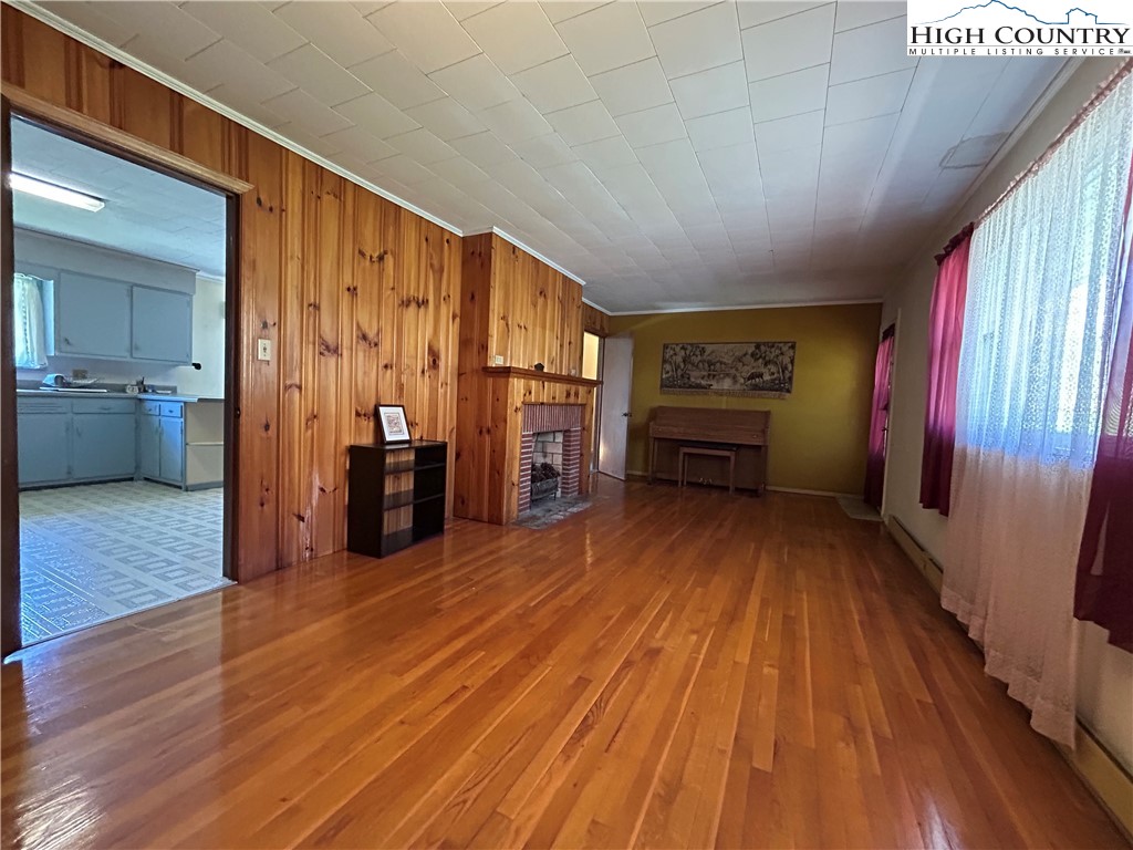 116 Cole Street Boone, NC 28607 - Photo 3 of 21 wooden floor in an empty room with a fireplace
