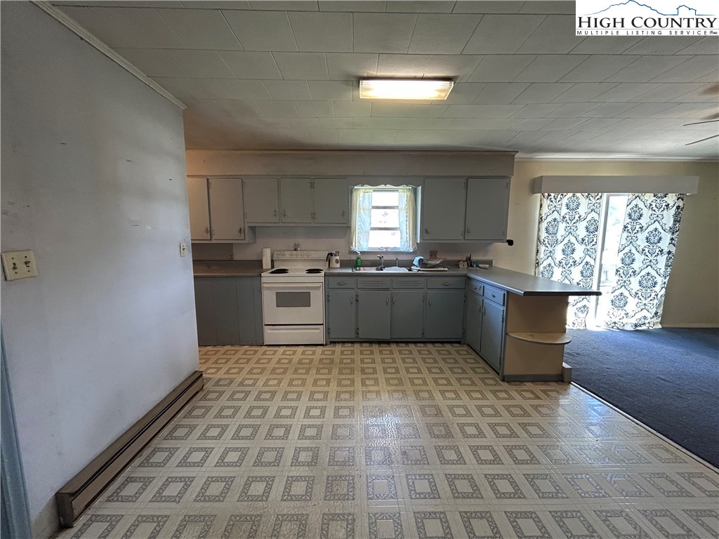 116 Cole Street Boone, NC 28607 - Photo 6 of 21 a kitchen with stainless steel appliances granite countertop a stove a sink and a refrigerator
