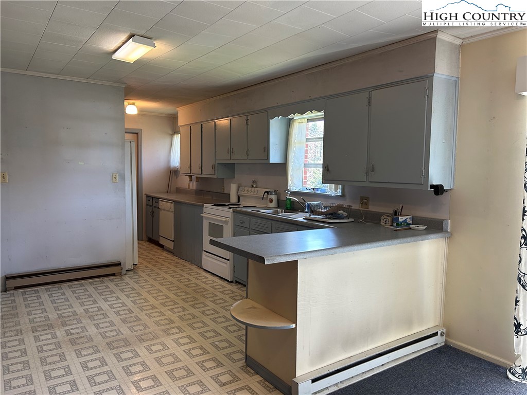 116 Cole Street Boone, NC 28607 - Photo 7 of 21 a kitchen with stainless steel appliances granite countertop a sink stove and refrigerator
