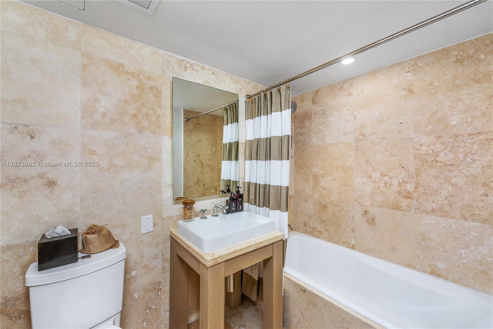 102 24th Street, Unit 1544 Miami Beach, FL 33139 - Photo 11 of 20 a bathroom with a sink and a mirror