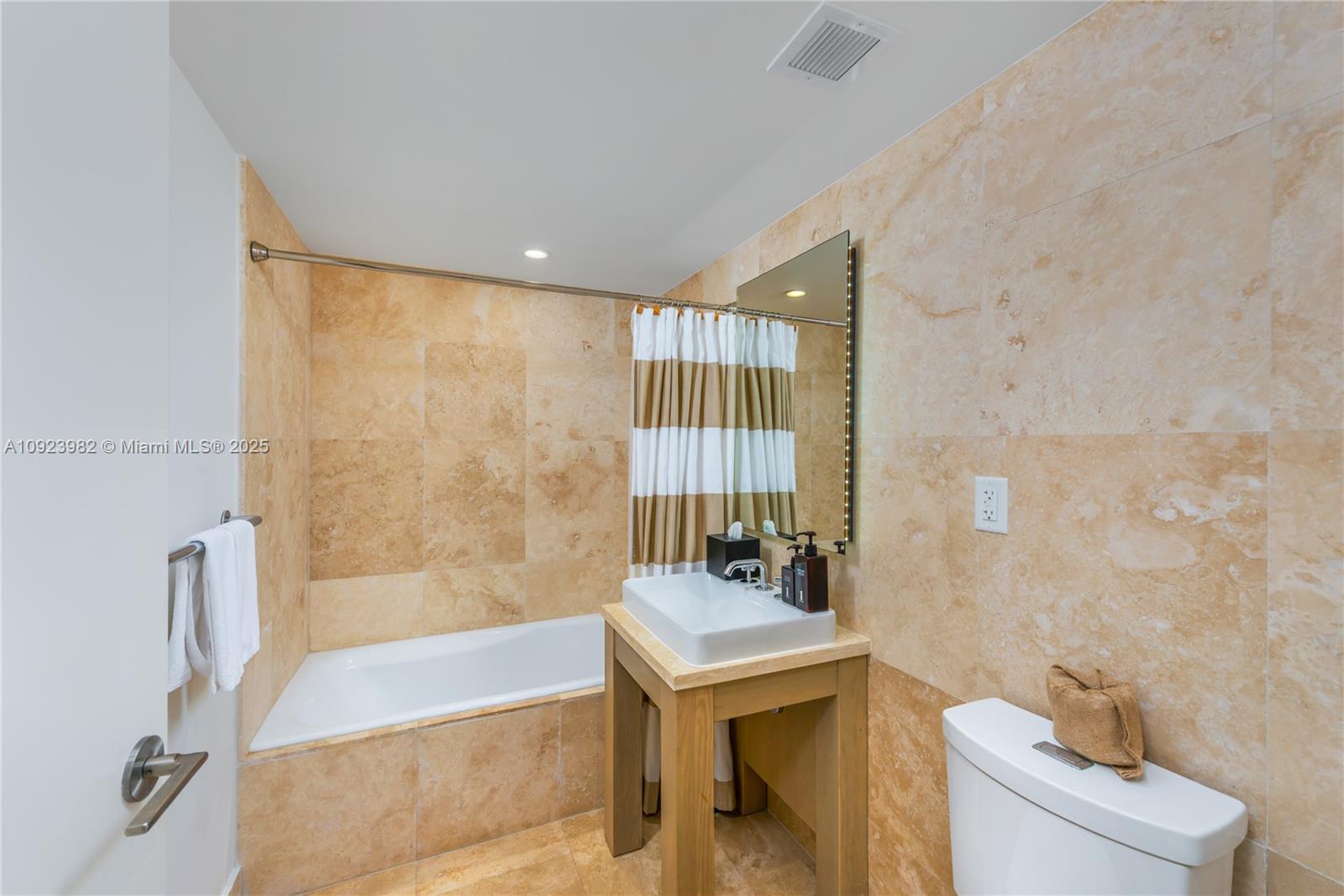 102 24th Street, Unit 1544 Miami Beach, FL 33139 - Photo 15 of 20 a bathroom with a bathtub and sink