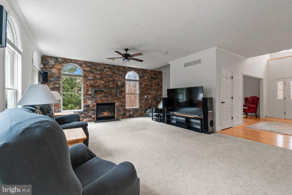 1633 Freeland Road Freeland, MD 21053 - Photo 15 of 73 a living room with furniture a flat screen tv and a fireplace