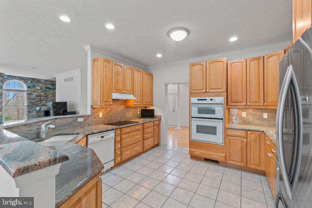 1633 Freeland Road Freeland, MD 21053 - Photo 19 of 73 a kitchen with stainless steel appliances granite countertop a sink and cabinets