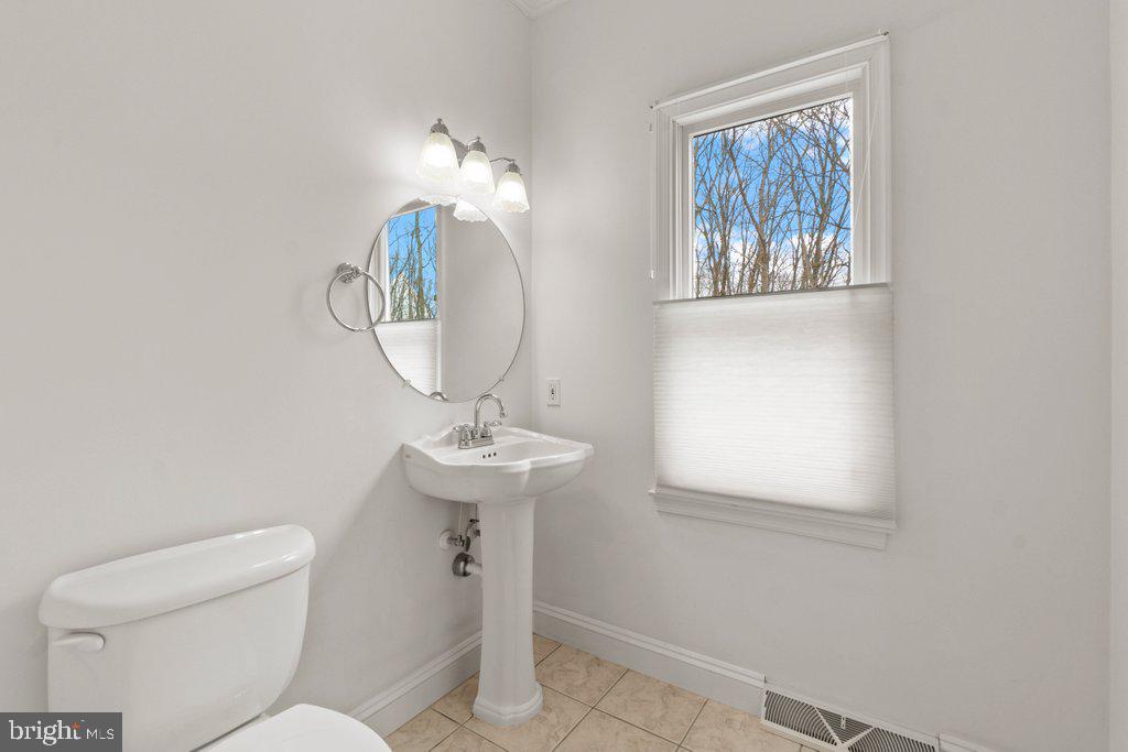 1633 Freeland Road Freeland, MD 21053 - Photo 26 of 73 a bathroom with a toilet a sink and a mirror