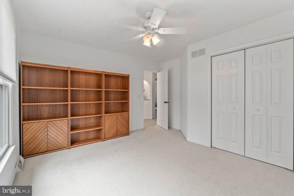 1633 Freeland Road Freeland, MD 21053 - Photo 34 of 73 a view of an empty room with a cabinet and a ceiling fan