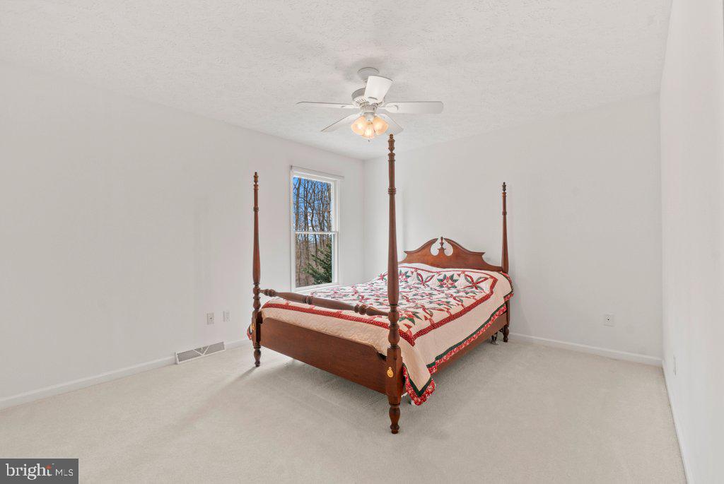 1633 Freeland Road Freeland, MD 21053 - Photo 37 of 73 a bedroom with a bed and a chandelier
