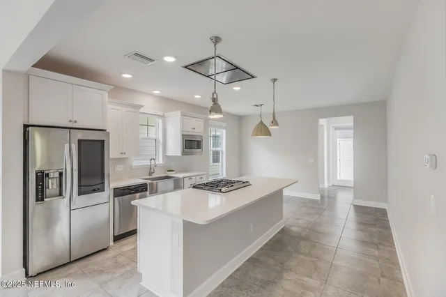 a kitchen that has a refrigerator a stove and a sink