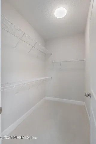 a view of a patio with table and chairs with wooden floor and fence
