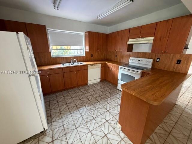 3112 Southwest 17th Street, Unit 3112 Miami, FL 33145 - Photo 5 of 12 a kitchen with stainless steel appliances granite countertop a refrigerator stove and sink