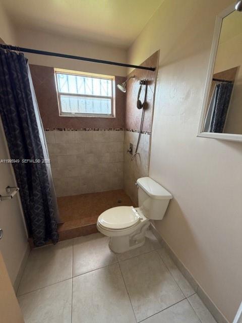 3112 Southwest 17th Street, Unit 3112 Miami, FL 33145 - Photo 8 of 12 a bathroom with a toilet a sink and a mirror