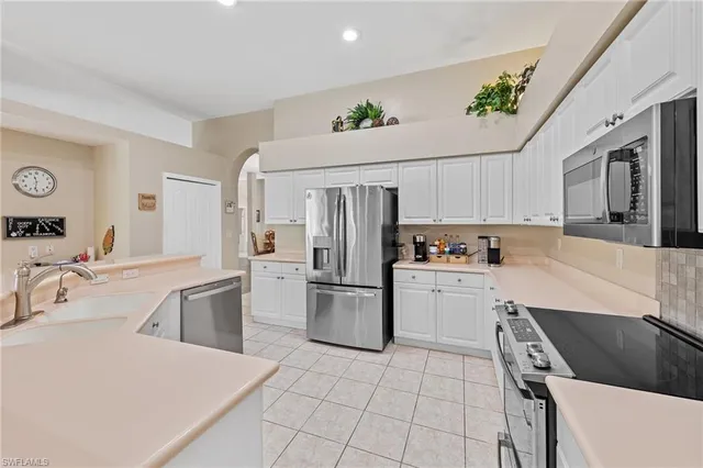 a kitchen with a sink cabinets and stainless steel appliances